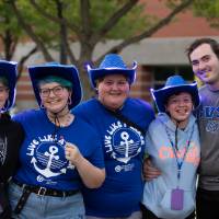 group of students wearing blue cowboy hats